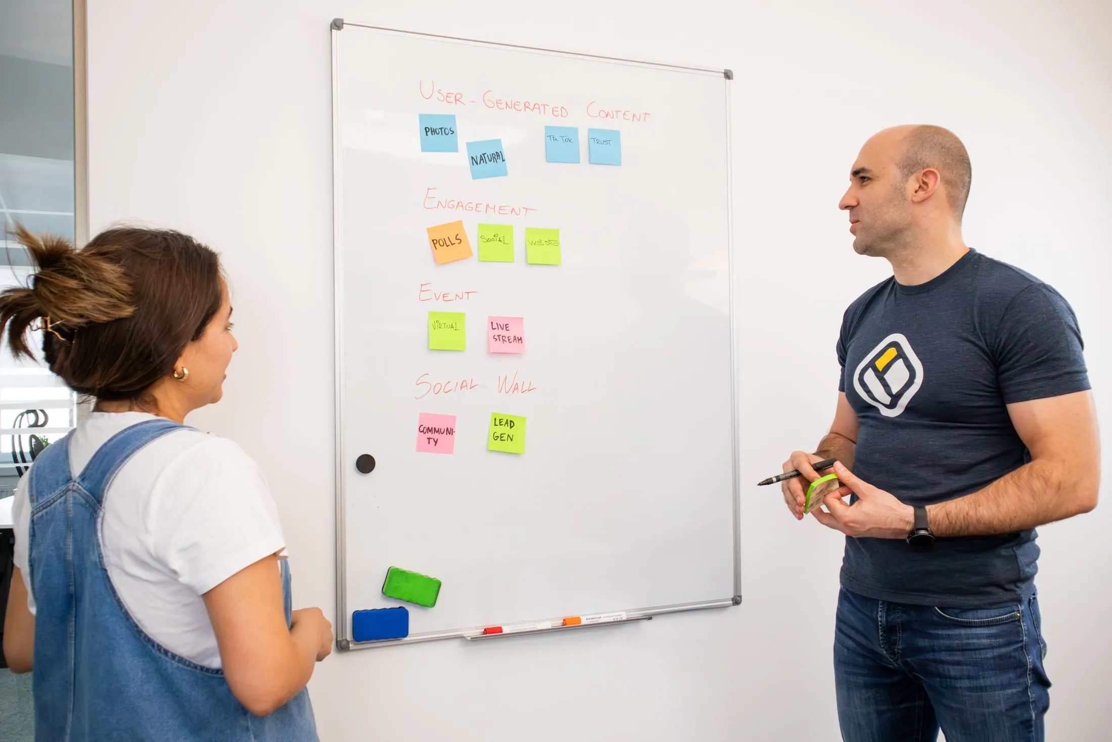 Colleagues planning a program together at a whiteboard