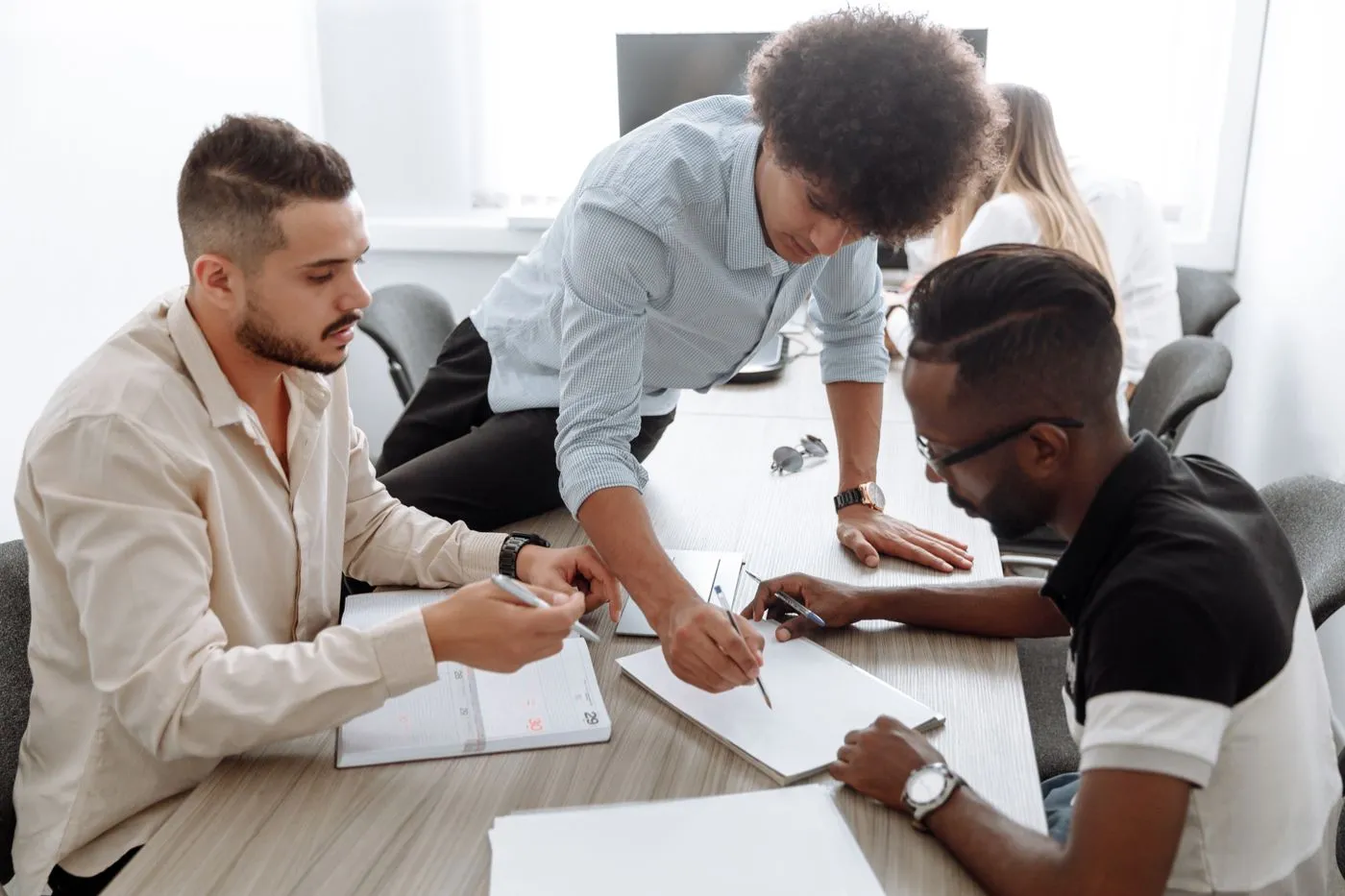 A team working together on documents around a table